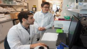 Co-lead author Ali Zamat and Gabe Kwong look over their work.