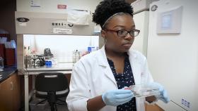 Yasmine Stewart, a biology major from Savannah State University, worked in the laboratory of Lohitash Karumbaiah, assistant professor in the College of Agricultural &amp; and Environmental Sciences at the University of Georgia. (Credit: Brice Zimmerman, Georgia Tech)