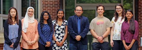 Ahmet Coskun (fourth from right) is flanked by members of the BioE Media Lab. Lead author of the paper on digital posters, Mythreye Venkatesan, is at far right.