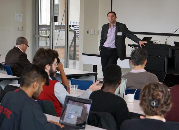 Chris Rozell addresses the room during the Intelligent Interactions with the Brain (I2B) Workshop.