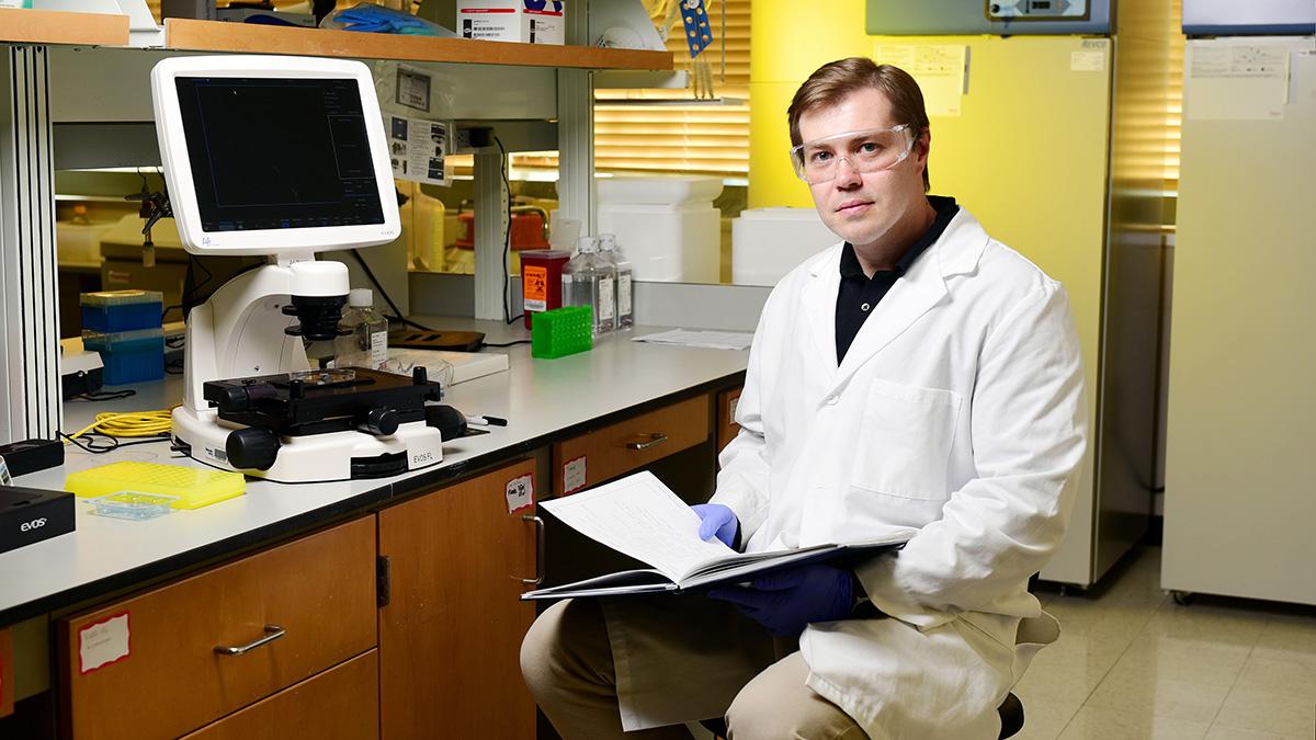 Denis Tsygankov sitting in his lab